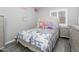Comfortable bedroom with a patterned comforter, and side table with great natural light and calming color palette at 1015 E Paradise Ln, Phoenix, AZ 85022