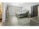 This bedroom features a stylish bed, wood floors, shutters, a TV, and neutral paint at 1015 E Paradise Ln, Phoenix, AZ 85022