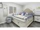 Cozy bedroom with a neutral color palette, features a comfortable bed with storage drawers and natural light at 1015 E Paradise Ln, Phoenix, AZ 85022