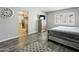 This bedroom showcases a bed, wood floors, a flat screen TV, and bright window shutters at 1015 E Paradise Ln, Phoenix, AZ 85022