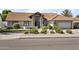 Charming single-story home showcasing a red tile roof, landscaped front yard, and inviting stone entryway at 1015 E Paradise Ln, Phoenix, AZ 85022