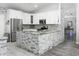 Bright kitchen featuring white cabinetry, granite countertops, stainless steel appliances, and an island with seating at 1015 E Paradise Ln, Phoenix, AZ 85022