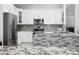 Well-equipped kitchen with stainless steel appliances, granite countertops, and stylish backsplash, creating a culinary haven at 1015 E Paradise Ln, Phoenix, AZ 85022