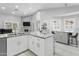 Spacious kitchen with white cabinets, granite countertops, stainless steel appliances, and an open layout concept at 1015 E Paradise Ln, Phoenix, AZ 85022