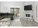 Cozy living room with plank flooring, stone fireplace, and sliding glass doors at 1015 E Paradise Ln, Phoenix, AZ 85022