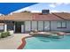 Backyard pool with attached hot tub, and view of the home with shutters and a red tile roof at 1015 E Paradise Ln, Phoenix, AZ 85022