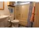 Cozy bathroom featuring a toilet, sink, shower-tub combo and blue patterned shower curtain at 11596 W Sierra Dawn Blvd # 182, Surprise, AZ 85378
