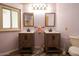 Bathroom showcasing dual sinks, wood-look floors, and wood-look cabinets and a view of the shower at 11596 W Sierra Dawn Blvd # 182, Surprise, AZ 85378