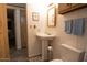 Bathroom with a toilet, sink, wood-look floors and a view into another room at 11596 W Sierra Dawn Blvd # 182, Surprise, AZ 85378