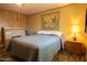 Cozy bedroom featuring a comfortable bed, wood-look floors and vintage wall decor and furniture at 11596 W Sierra Dawn Blvd # 182, Surprise, AZ 85378