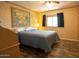 Bedroom featuring a cozy bed with vintage art hanging on the wall and wood-look flooring at 11596 W Sierra Dawn Blvd # 182, Surprise, AZ 85378