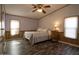 Bright bedroom featuring a bed with floral bedding, natural light, and wood-look floors at 11596 W Sierra Dawn Blvd # 182, Surprise, AZ 85378