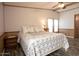 Bedroom showcasing a bed with floral bedding, vintage furniture, and wood-look floors at 11596 W Sierra Dawn Blvd # 182, Surprise, AZ 85378