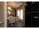 Charming dining area with warm lighting and wood-style floors adjacent to a modern refrigerator, blending style with convenience at 11596 W Sierra Dawn Blvd # 182, Surprise, AZ 85378