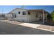 Charming single-story home with carport, landscaped front yard, and easy access to nearby amenities at 11596 W Sierra Dawn Blvd # 182, Surprise, AZ 85378