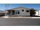 Inviting single-story home featuring a covered carport, landscaped front yard, and decorative exterior accents at 11596 W Sierra Dawn Blvd # 182, Surprise, AZ 85378
