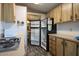 The well-appointed kitchen offers modern appliances, wood cabinets, and easy access to the dining area through an open layout at 11596 W Sierra Dawn Blvd # 182, Surprise, AZ 85378