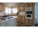 This kitchen features modern appliances, including an electric cooktop, complemented by abundant wood cabinetry and counter space at 11596 W Sierra Dawn Blvd # 182, Surprise, AZ 85378
