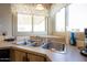 Well-lit kitchen sink with updated fixtures and neutral countertops, creating a functional and inviting space at 11596 W Sierra Dawn Blvd # 182, Surprise, AZ 85378