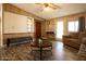 Bright living room with wood-look floors, cozy seating, and multiple entry points at 11596 W Sierra Dawn Blvd # 182, Surprise, AZ 85378