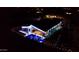 Aerial night view of a modern home with a lighted backyard including a pool, spa and outdoor seating at 1217 E Monte Way, Phoenix, AZ 85042