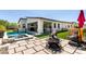 Backyard oasis featuring a pool, spa, artificial turf, patio, and fire pit at 1217 E Monte Way, Phoenix, AZ 85042
