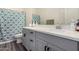 Bathroom showcasing a modern vanity with gray cabinets and a stylish shower curtain at 1217 E Monte Way, Phoenix, AZ 85042