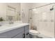 Well-lit bathroom with modern vanity, a walk-in shower with glass doors, and updated fixtures at 1217 E Monte Way, Phoenix, AZ 85042