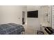 This bedroom boasts an en suite bath and a wall-mounted television at 1217 E Monte Way, Phoenix, AZ 85042