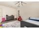 Bright bedroom with gray dresser, ceiling fan, geometric rug, and a bed with blue accents at 1217 E Monte Way, Phoenix, AZ 85042