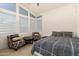 This naturally lit bedroom features ample window space and modern accent chairs at 1217 E Monte Way, Phoenix, AZ 85042