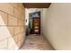 Stylish entryway with a modern orange door, stone wall, and neutral color palette at 1217 E Monte Way, Phoenix, AZ 85042