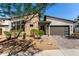 Modern home with stone accents, desert landscaping and a covered two-car garage at 1217 E Monte Way, Phoenix, AZ 85042