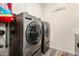 Functional laundry room with side-by-side washer and dryer, and built-in cabinetry at 1217 E Monte Way, Phoenix, AZ 85042
