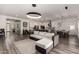 Open-concept living room with a modern sofa, light fixtures and a spacious kitchen at 1217 E Monte Way, Phoenix, AZ 85042