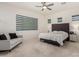 This main bedroom features a cozy sitting area, neutral carpet, and an upholstered headboard at 1217 E Monte Way, Phoenix, AZ 85042