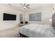 This main bedroom includes a ceiling fan, a sitting area and modern horizontal blinds at 1217 E Monte Way, Phoenix, AZ 85042