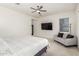This spacious main bedroom features a ceiling fan, natural light and a cozy sitting area at 1217 E Monte Way, Phoenix, AZ 85042