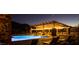 Tranquil community pool area with lounge chairs and pergola lighting, perfect for relaxing evenings at 1217 E Monte Way, Phoenix, AZ 85042