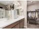 Bathroom featuring double sinks, white counters and cabinets, and access to the walk-in closet at 1284 W Sussex St, San Tan Valley, AZ 85143