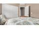Bedroom with a floral patterned bedspread and white closet with sliding doors at 1284 W Sussex St, San Tan Valley, AZ 85143