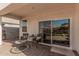 Relaxing covered patio with decorative furniture and a sliding door to the home at 1284 W Sussex St, San Tan Valley, AZ 85143