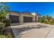 Low angle view of a single-Gathering home features a neutral exterior, well-maintained landscaping, and a spacious three-car garage at 1284 W Sussex St, San Tan Valley, AZ 85143