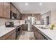Modern kitchen features stainless steel appliances, ample counter space, and sleek cabinetry at 1284 W Sussex St, San Tan Valley, AZ 85143