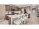 Well-equipped kitchen features stainless steel appliances, kitchen island with countertop seating, and stylish cabinets at 1284 W Sussex St, San Tan Valley, AZ 85143