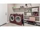 A well-organized laundry room with modern machines and shelving ready to be filled at 1284 W Sussex St, San Tan Valley, AZ 85143