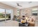 Inviting living room featuring an expansive sectional sofa, and sliding glass doors leading to outdoor patio at 1284 W Sussex St, San Tan Valley, AZ 85143