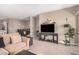 Comfortable living room features modern furniture, TV, and seamlessly transitions into the dining area at 1284 W Sussex St, San Tan Valley, AZ 85143