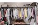Spacious walk-in closet with lots of shelving and clothes hanging ready to be filled at 1284 W Sussex St, San Tan Valley, AZ 85143