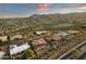 Scenic aerial view of a desert community with lush green golf course and mountain backdrop at sunset at 15600 E Robin Dr, Fountain Hills, AZ 85268
